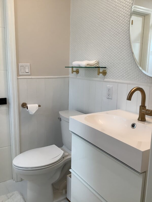 A bathroom with white walls and a sink.