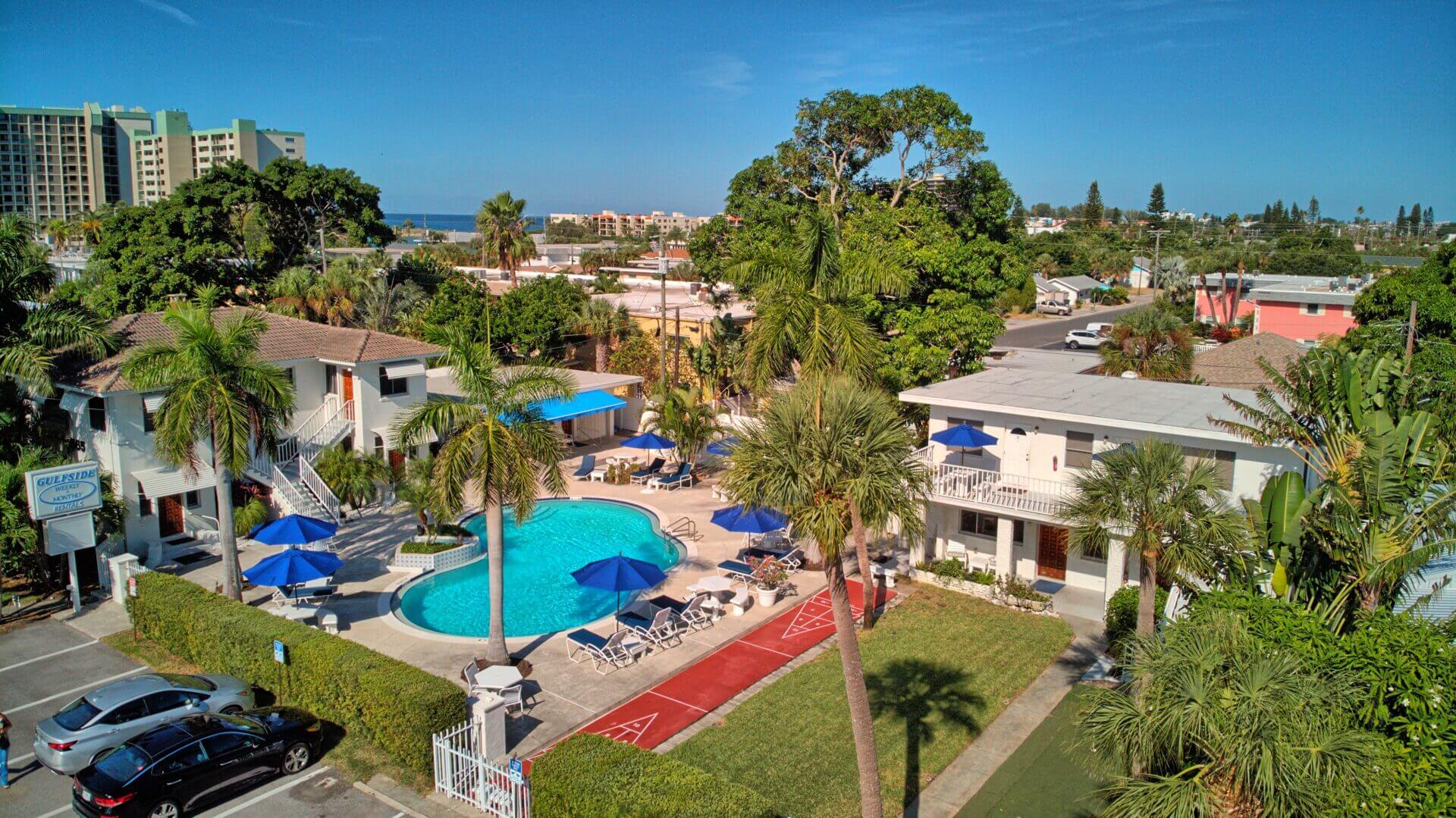 A view of an outdoor pool and some trees.